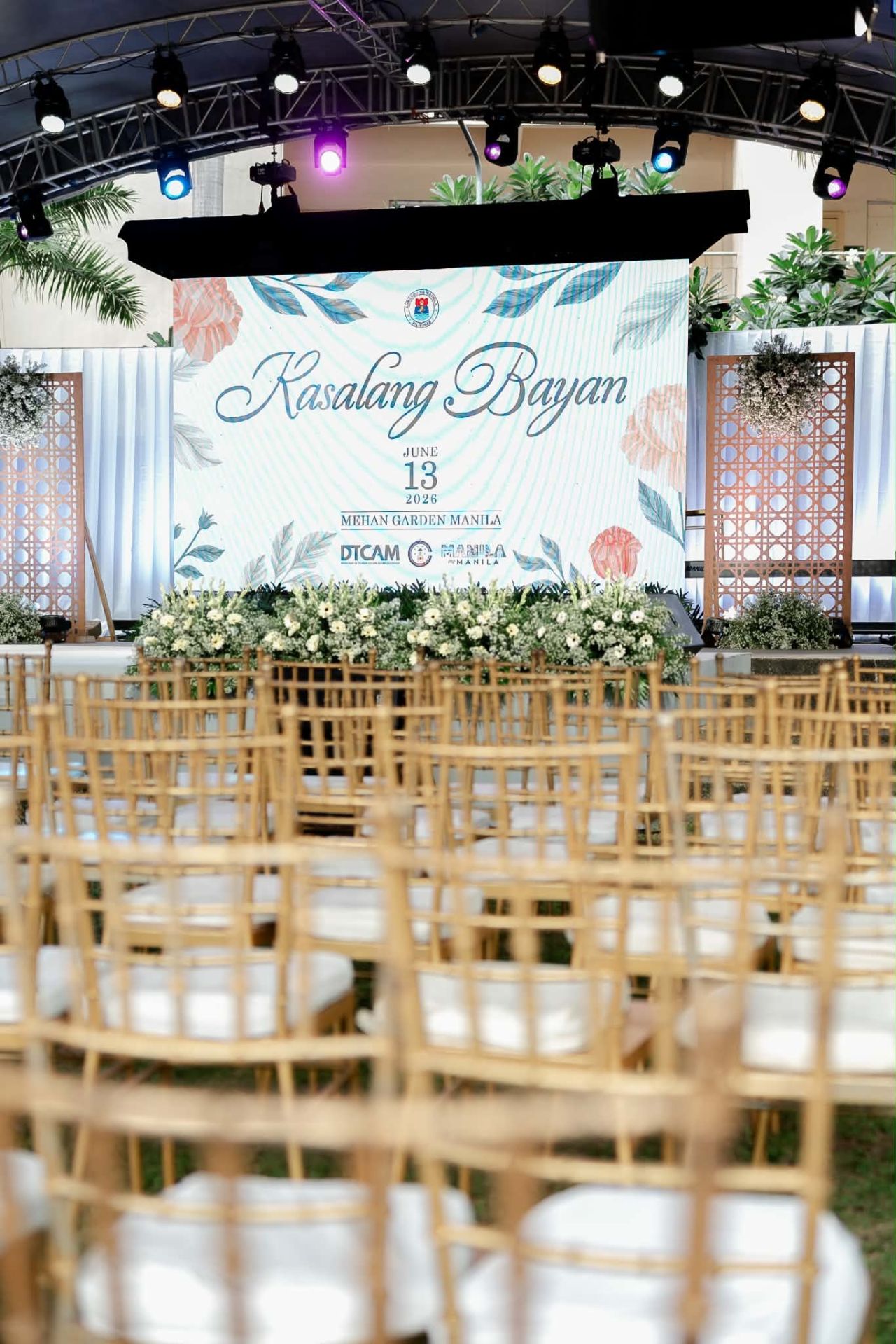 Truss-mounted moving lights above an LED backdrop